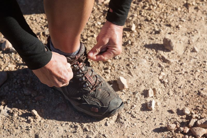 A female hiker lacing up her boots